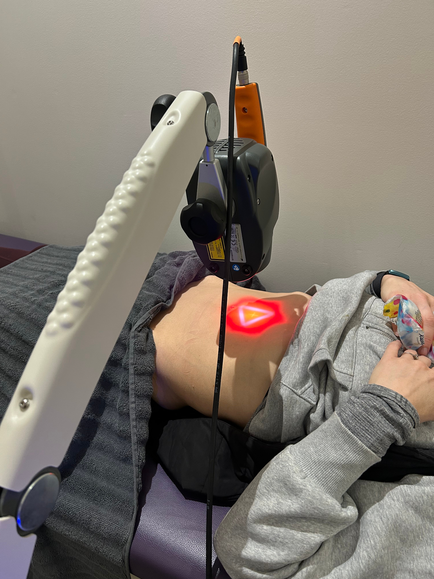 MLS laser therapy targeting abdominal area for gut health improvement and digestive pain relief treatment