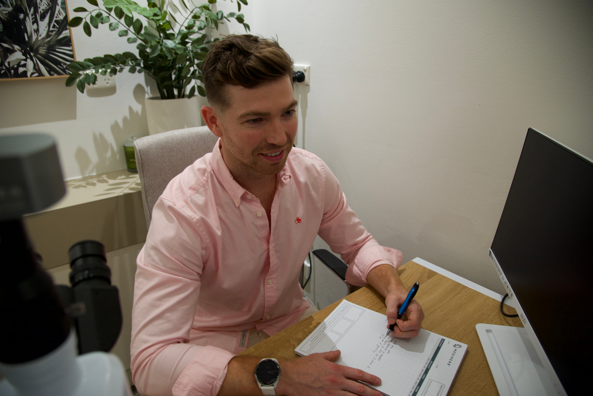 Naturopath showing patient results on a computer at NXTLVL Health