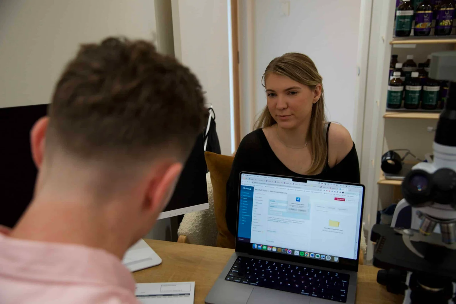 Naturopath consultation discussing bloating issues with patient